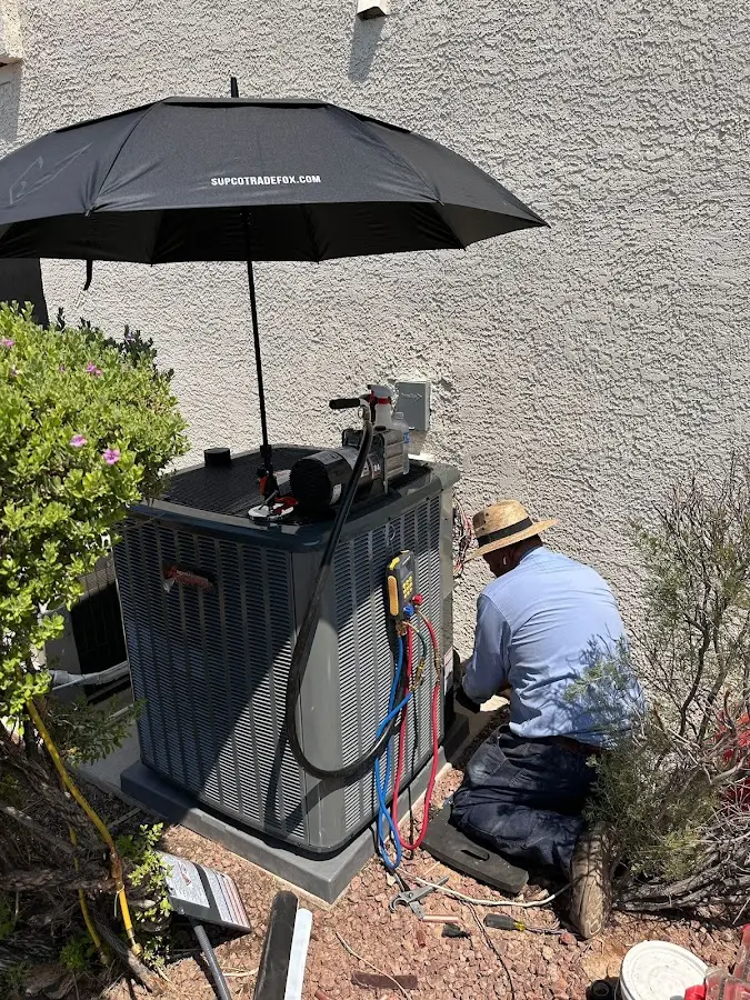 HVAC technician performing outdoor AC maintenance in Minnetonka